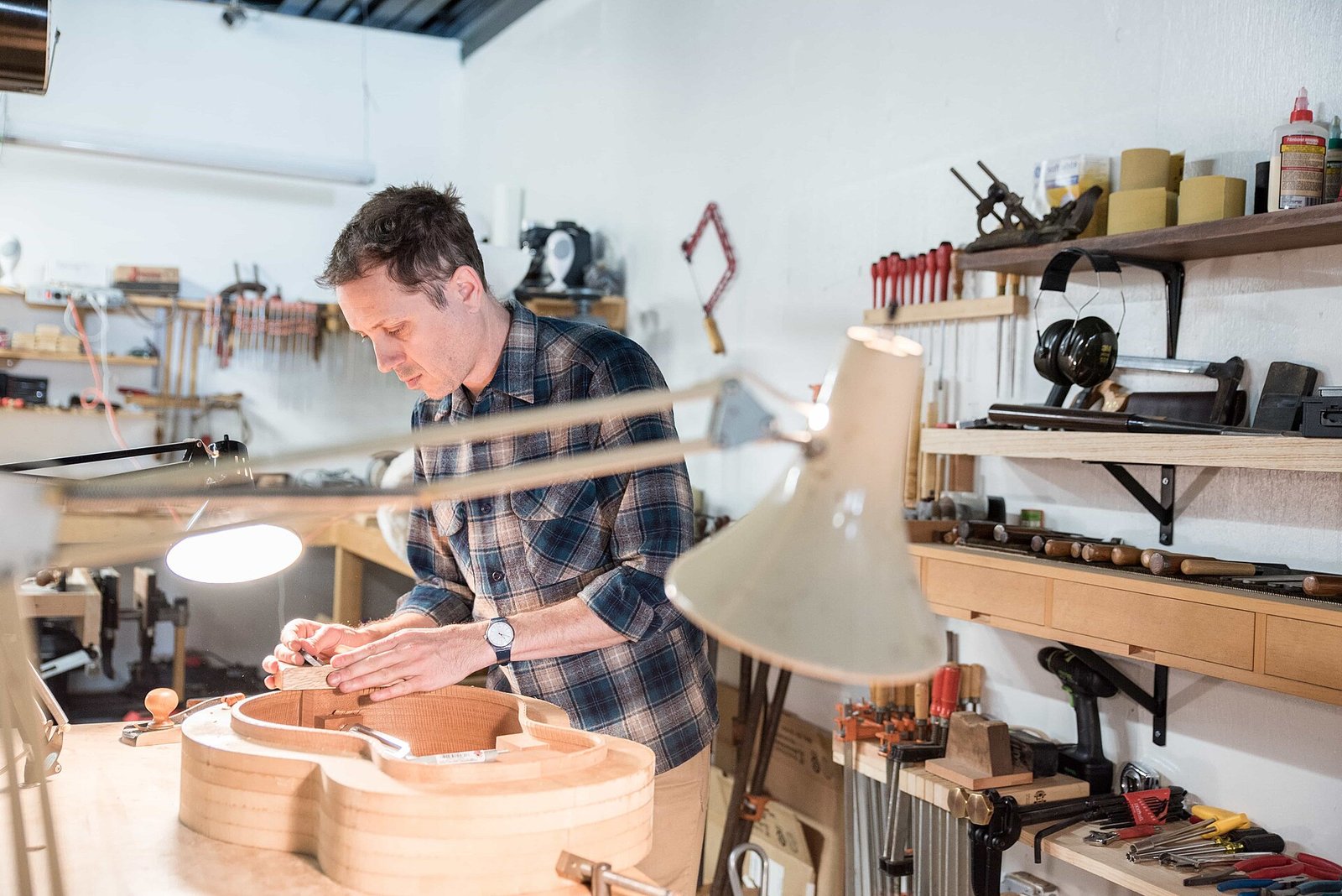 Luthier working on a guitar in a workshop